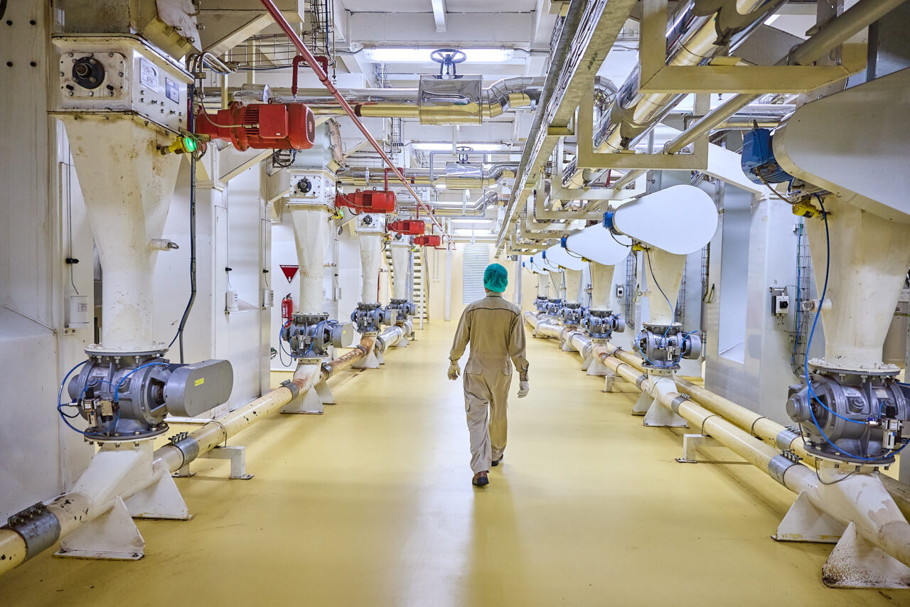 Man walking through a cocoa factory in Jakarta, Indonesia. Tyson Sadlo for deZaan